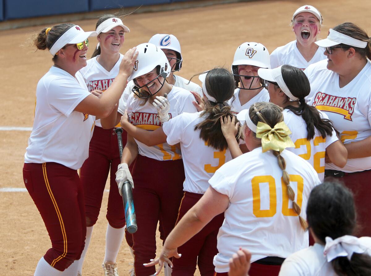 Ocean View sophomore Emma Craft, third from left, is mobbed by teammates after she scores the go-ahead run. 