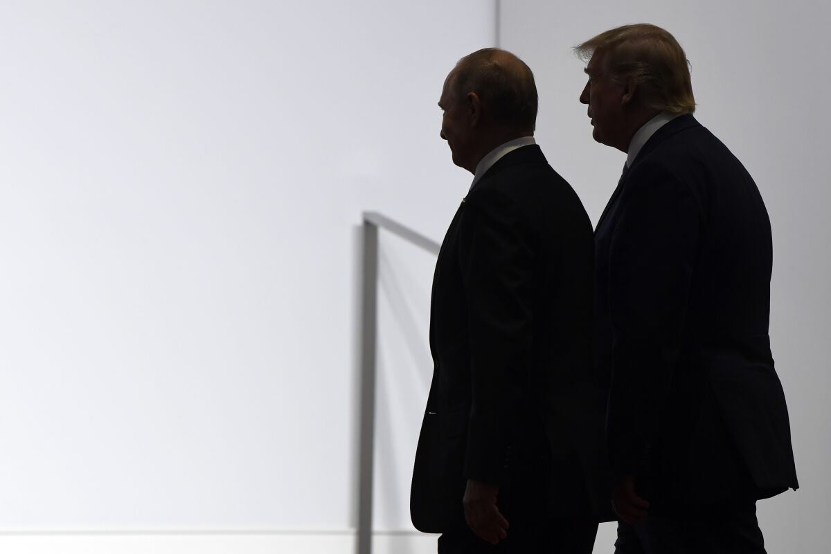 FILE - In this June 28, 2019, file photo President Donald Trump and Russian President Vladimir Putin walk to participate in a group photo at the G20 summit in Osaka, Japan. Most Americans are concerned at least somewhat by the potential for foreign interference in November’s election, and a majority believes that Russian sought in 2016 to influence the outcome of that race. (AP Photo/Susan Walsh, File)