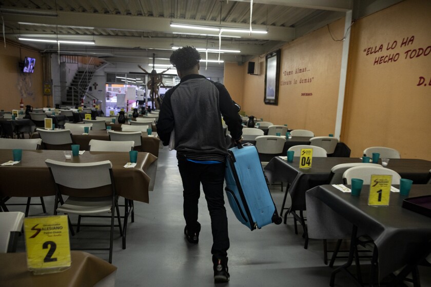 Adan, 30, heads to a van that will take him to San Diego's immigration court