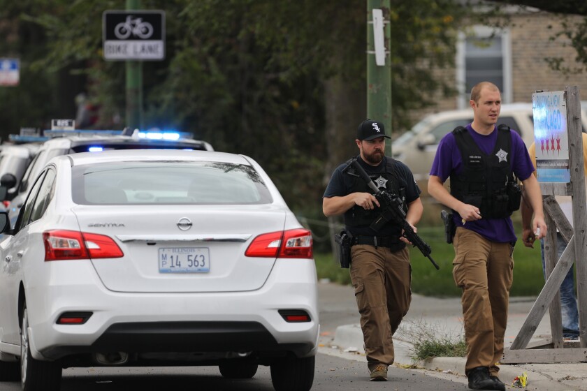 Police search for a suspect that shot a Chicago Police Department officer, near 63rd and Damen, Saturday, Sept. 21, 2019. The shooting happened around 8:40 a.m. (Abel Uribe/Chicago Tribune via AP)
