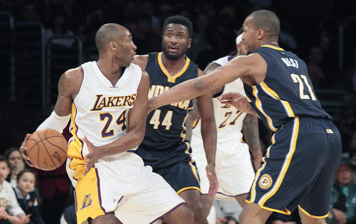 Pacers forwards David West (21) and Solomon Hill (44) cut off a drive by Lakers guard Kobe Bryant during their game last week.