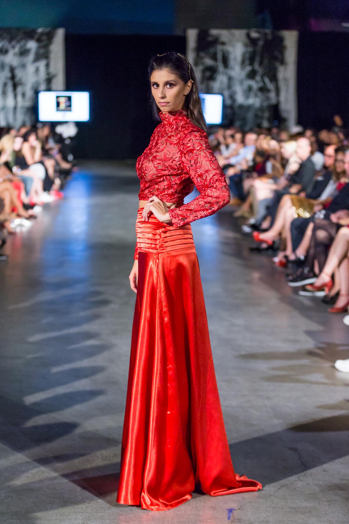 A model walks the runway at a previous Fashion Week San Diego event.