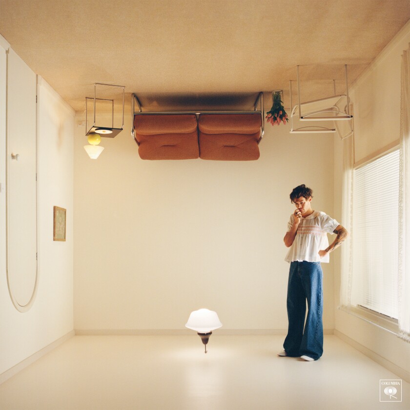 A man standing on the ceiling of an upside-down living room