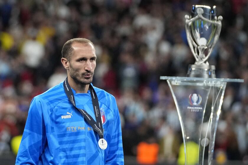 Italy's Giorgio Chiellini walks past the trophy at the end of the Finalissima soccer match 