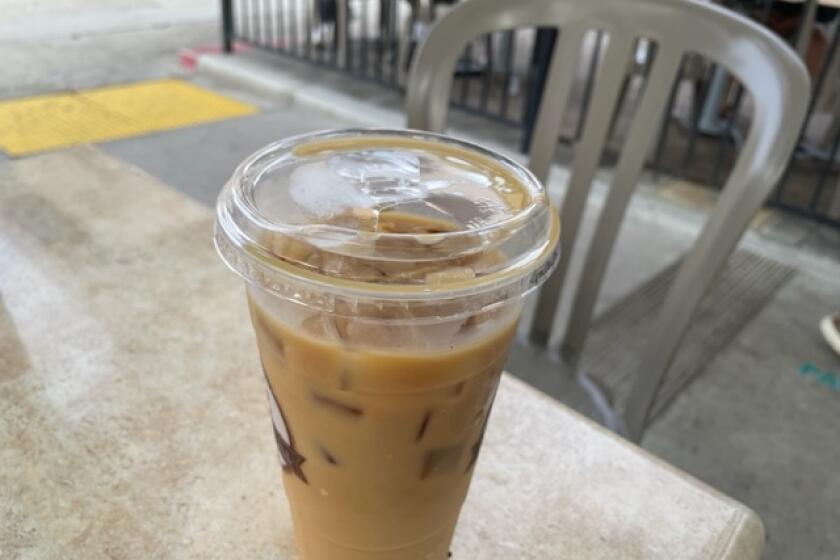 A large iced coffee and a waiting chair at Brick & Bell in La Jolla.