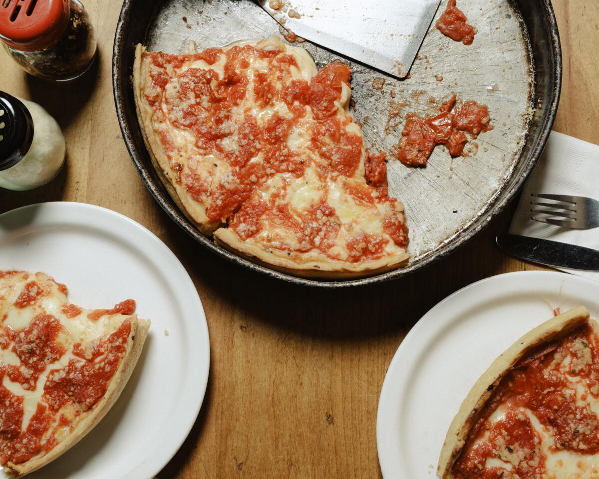 The deep dish pizza at Lou Malnati’s has a surprisingly thin, flaky crust that straddles pizza and pie dough.