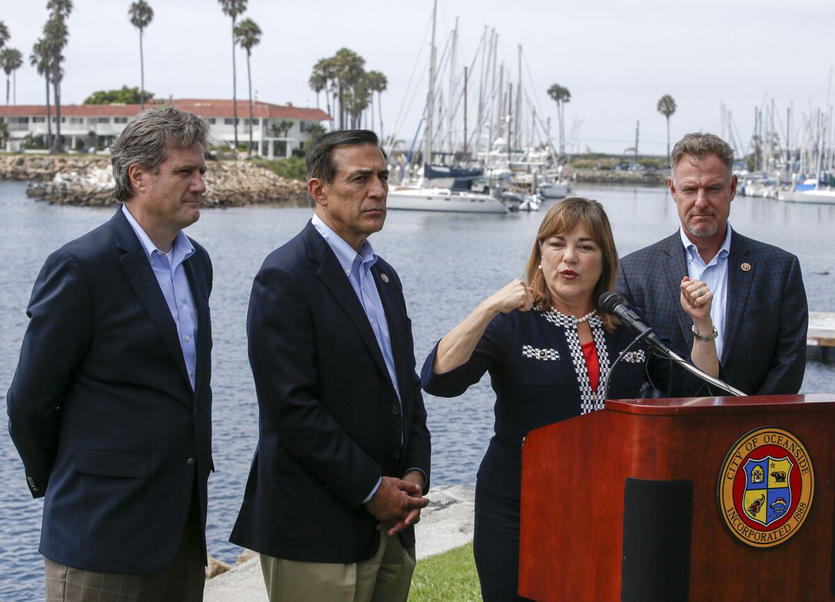Reps. Mike Turner, left, Darrell Issa, Loretta Sanchez and Scott Peters hold a news conference in Oceanside.