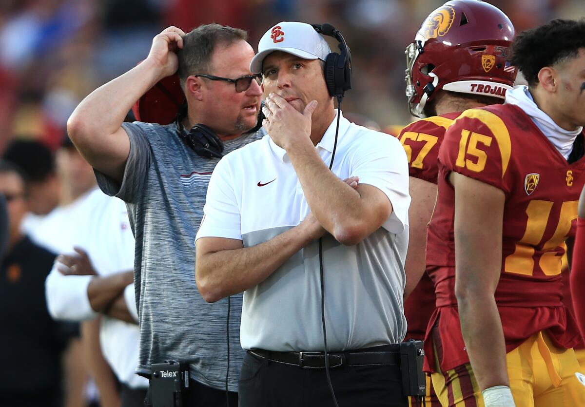 USC coach Clay Helton stands on the sideline.