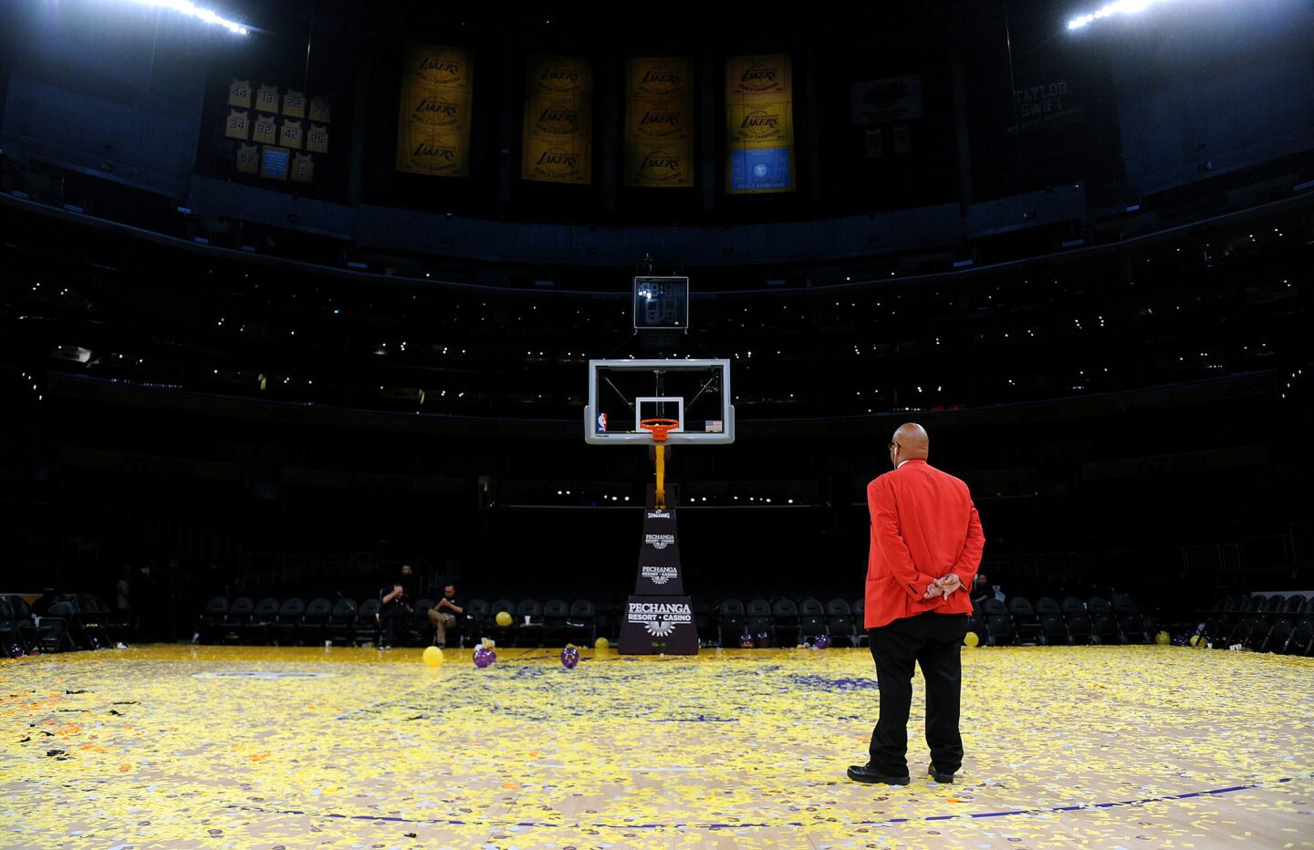 A security guard stnds alone on the court after Kobe Bryant's last game at the Staples Center Wednesday.