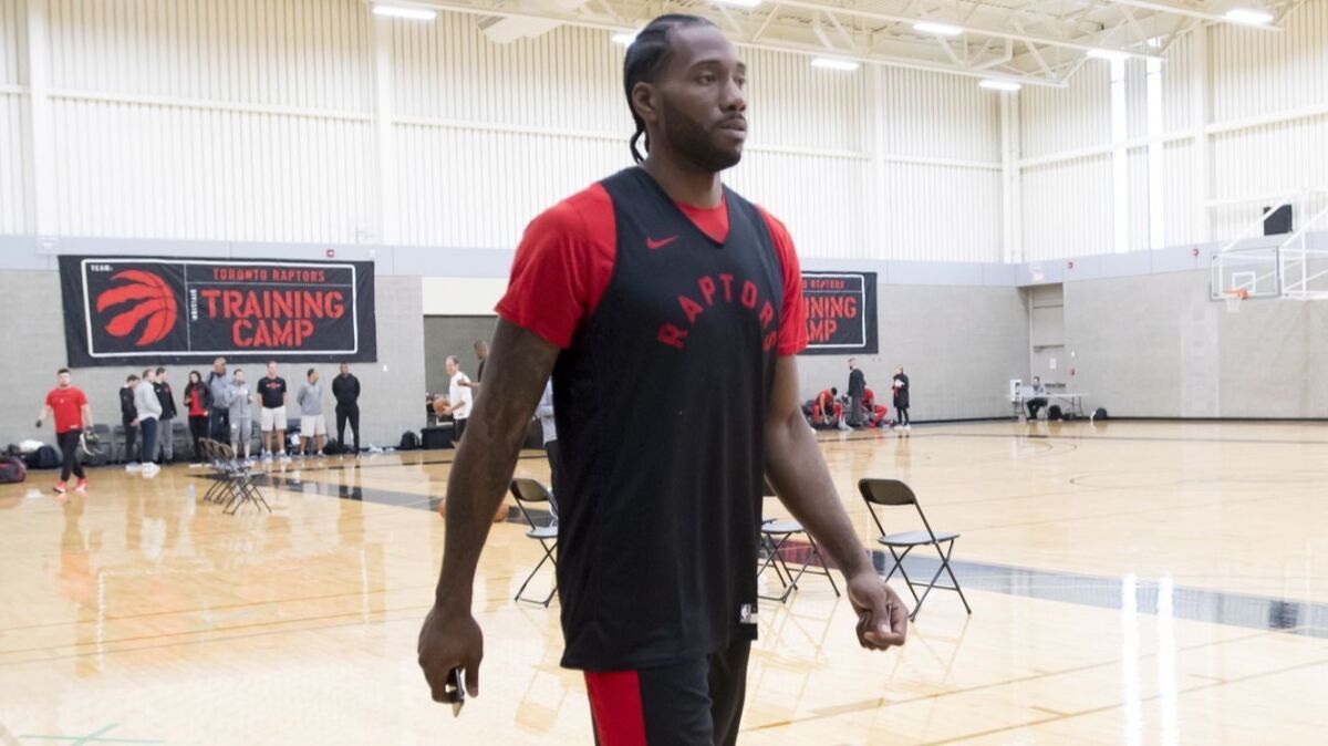Kawhi Leonard walks across the court before a practice at training camp in Burnaby, Canada.