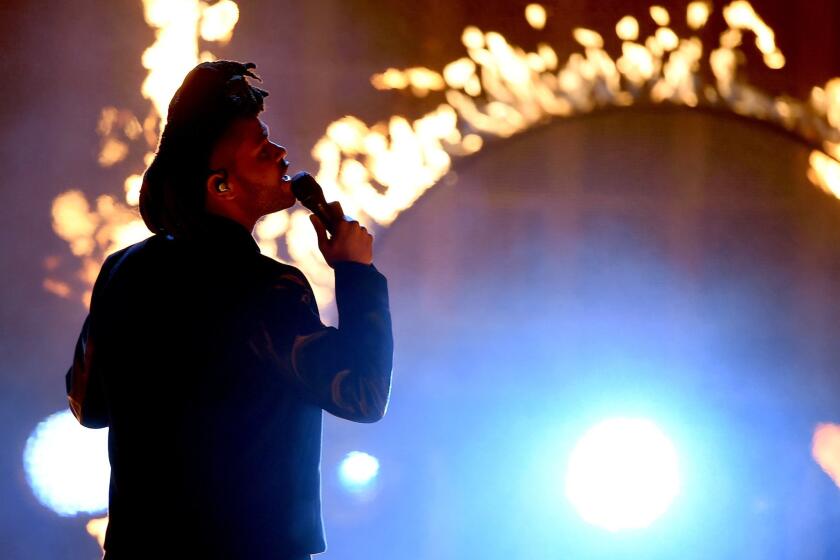 The Weeknd performs during the 2015 American Music Awards at Microsoft Theater in Los Angeles.