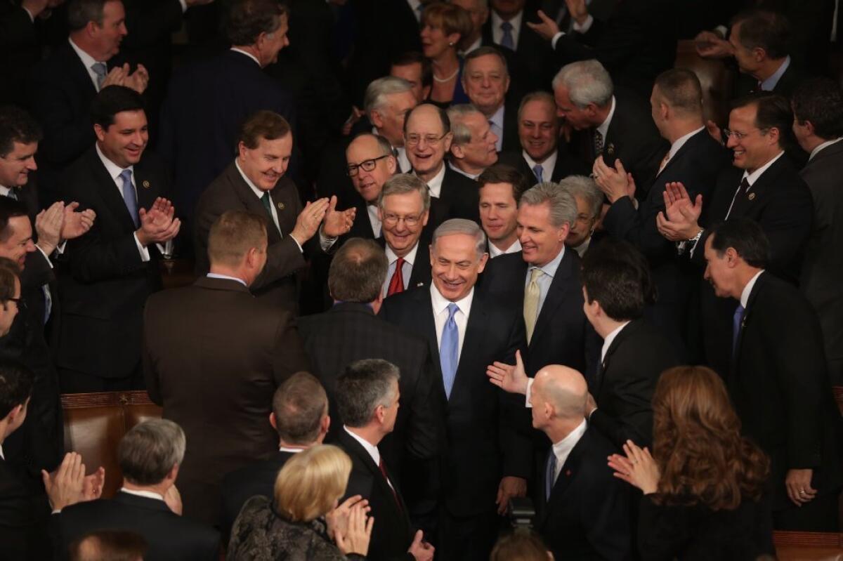 Israeli Prime Minister Benjamin Netanyahu is greeted by lawmakers as he arrives to speak during a joint session of Congress on Tuesday.