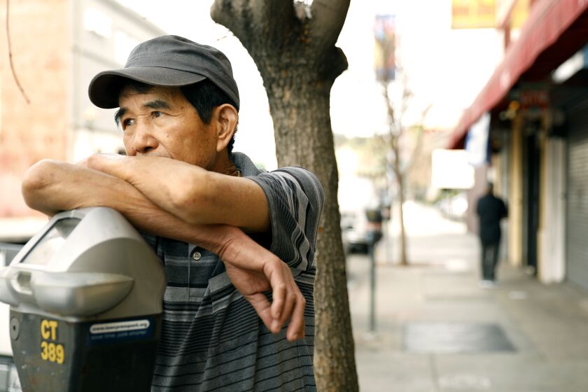 LOS ANGELES-CA-FEBRUARY 27, 2020: Luu Ha, 70, who works at Pho Hoa Vietnamese restaurant in Chinatown near downtown Los Angeles, waits outside for customers on Thursday, February 27, 2020. (Christina House / Los Angeles Times)