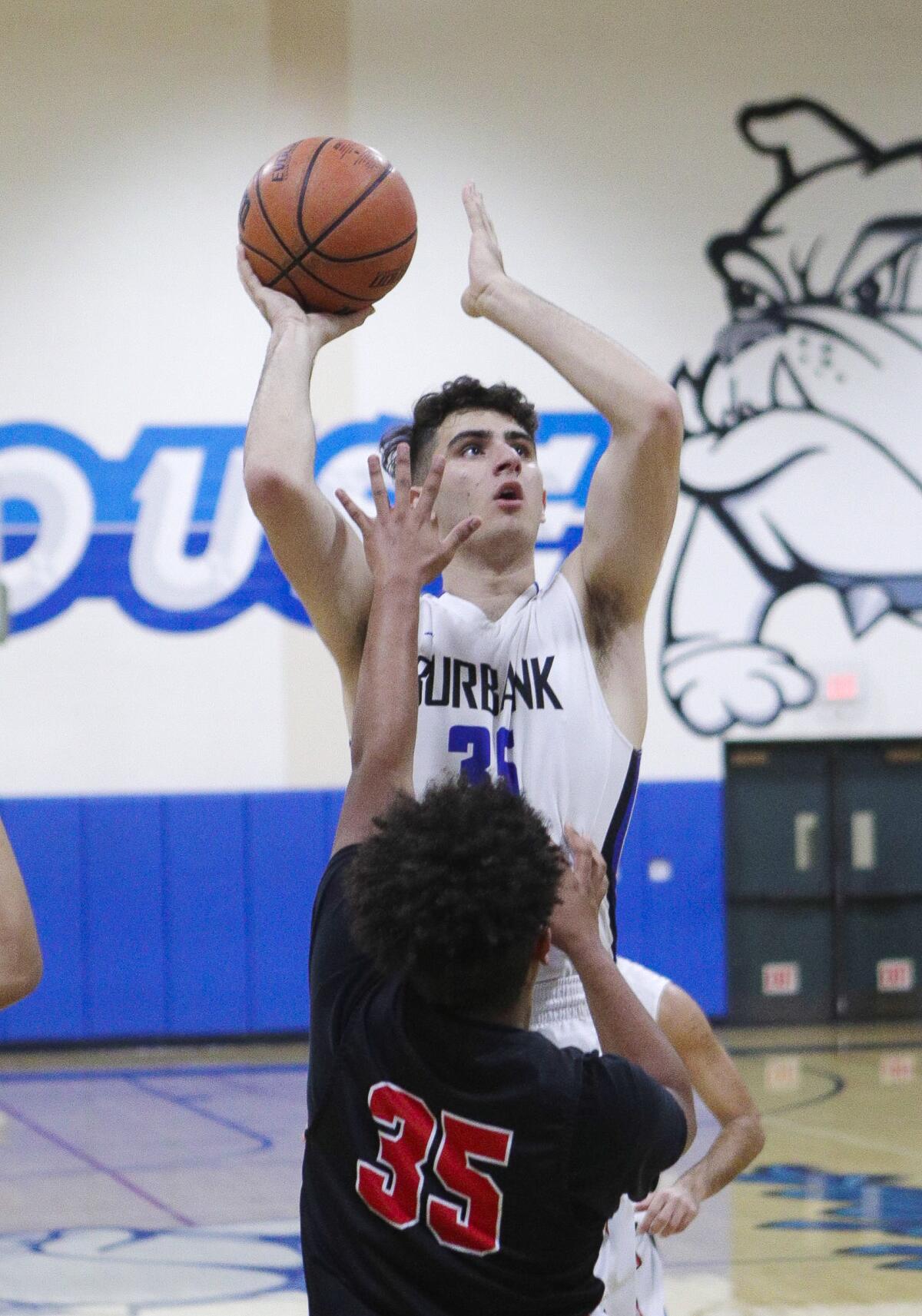 Burbank's Kevin Sarkes shoots over Glendale's Eric Torossian in a Pacific League boys' basketball game at Burbank High School on Friday, January 17, 2020.