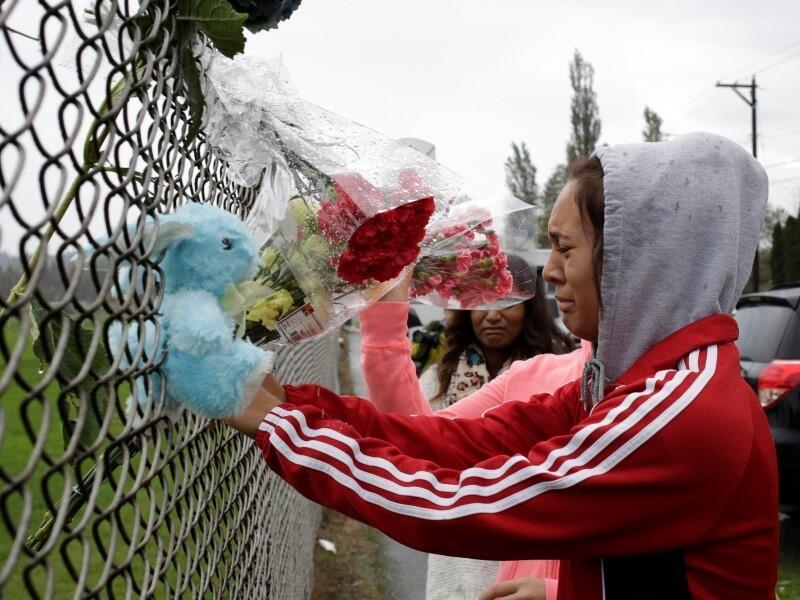 Student Tyanna Davis cries after placing flowers on a fence outside Marysville-Pilchuck High School the day after a shooting at the school in Marysville, Washington.