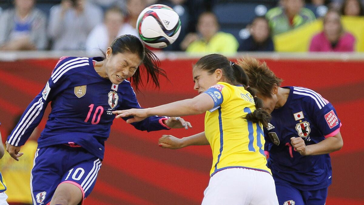 Japan's Homare Sawa, left, knocks the ball into the box with a header in front of Ecuador's Ligia Moreira during Japan's 1-0 victory on June 16.
