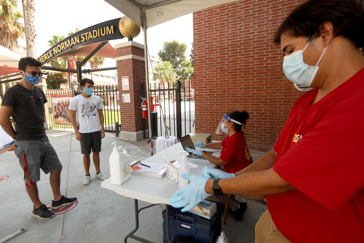 USC student Mitchell Steimle, 21, and his brother Anthony, 18, participate in a wellness check on the first day of classes.