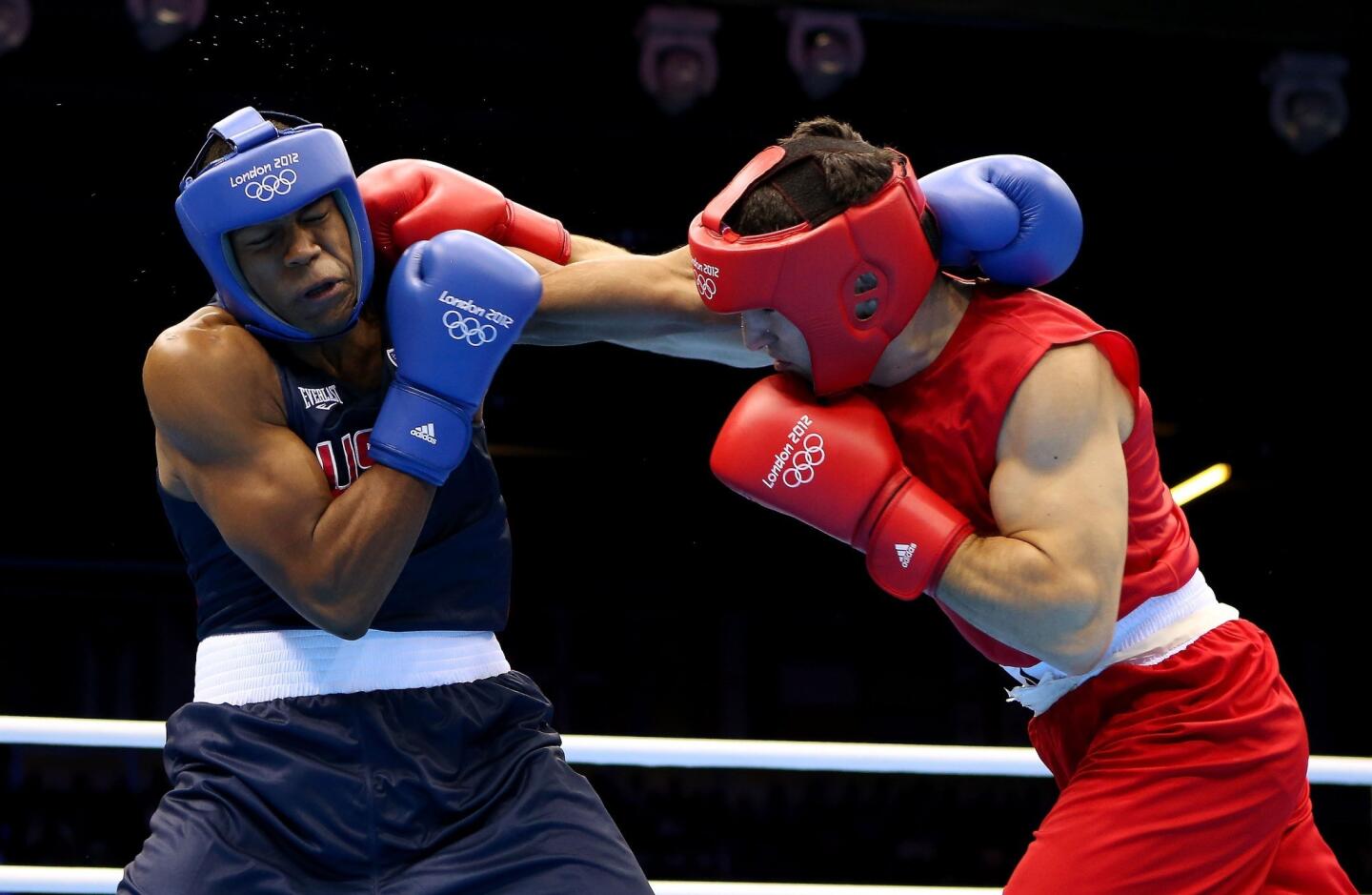 Artur Beterbiev of Russia, right, battles Michael Hunter II of United States during the men's heavy (91kg) boxing.