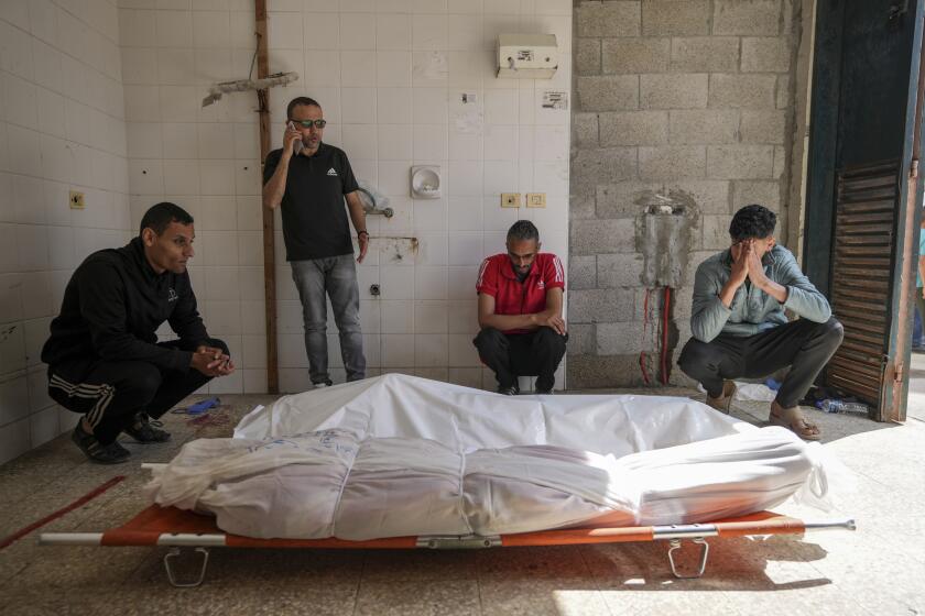 Palestinians react next to the bodies of their relatives who were killed in an Israeli airstrike in Gaza Stirp, at the Al Aqsa hospital in Deir al Balah, Gaza, Saturday, May 4, 2024. (AP Photo/Abdel Kareem Hana)