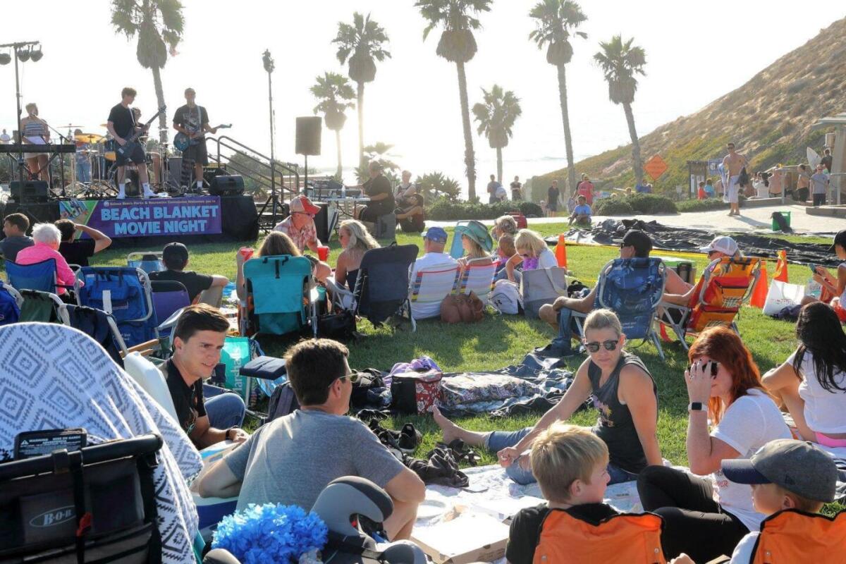 Participants enjoying a previous Beach Blanket Movie Night which also featured live music.