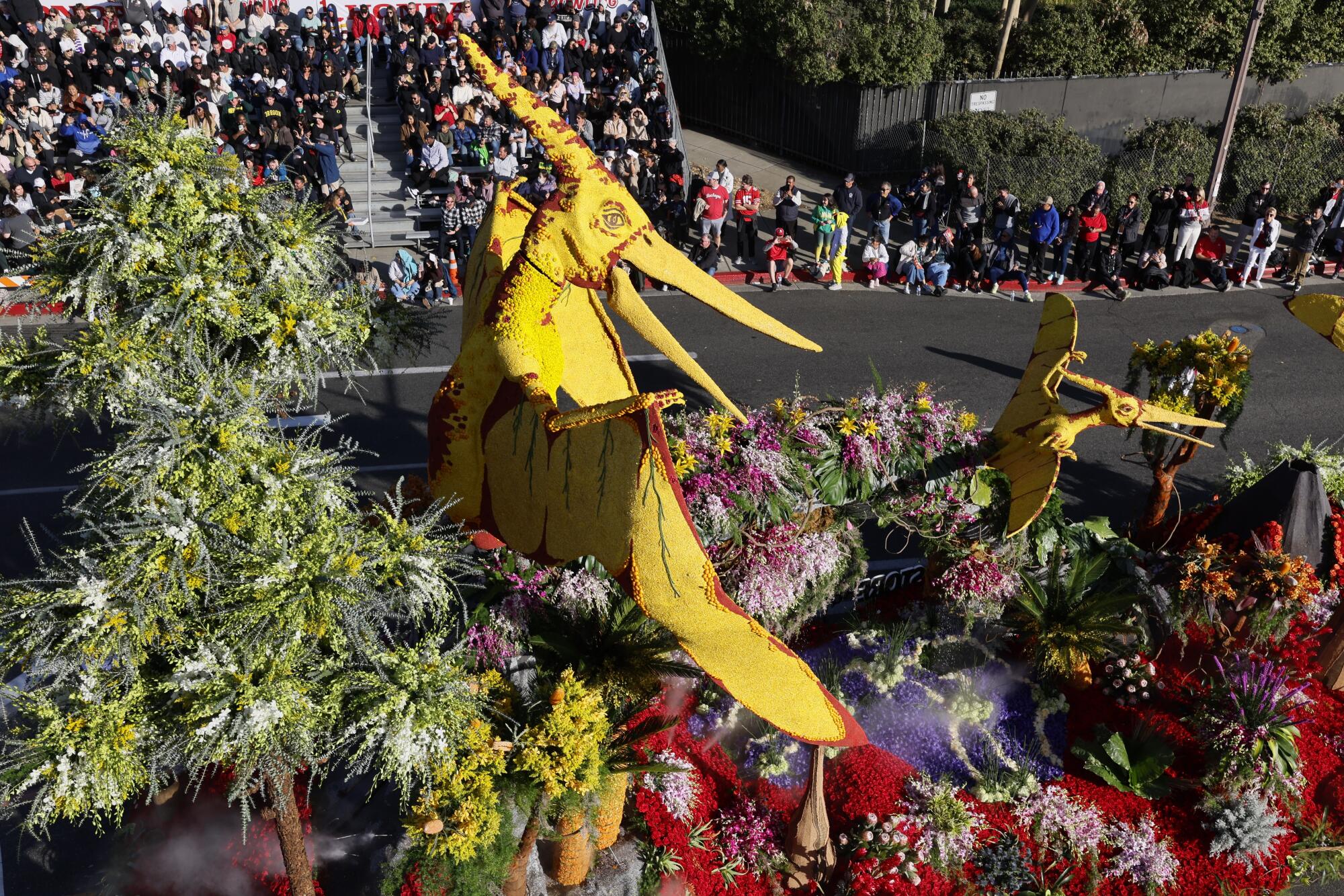 A parade float rolls down a street.