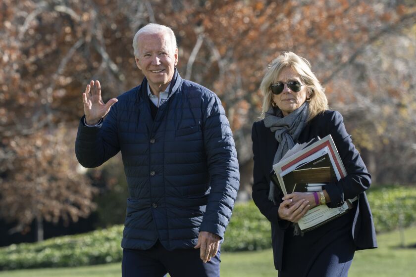 President Joe Biden and first lady Jill Biden walk on the South Lawn of the White House in Washington, upon arrival from spending the weekend at Camp David, Sunday, Dec. 4, 2022. (AP Photo/Manuel Balce Ceneta)
