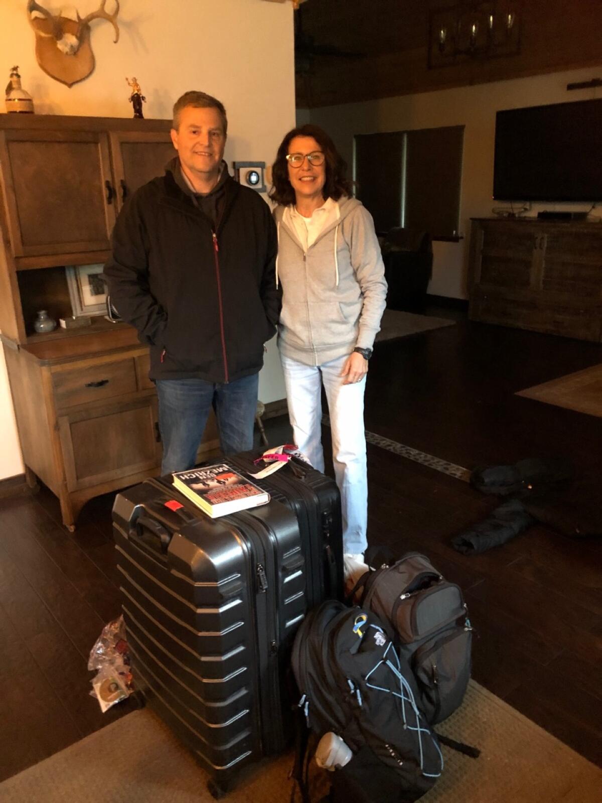 Bryan Haney and Diane Jones Haney pose for a photo at their house in Hayden, Idaho, before their flight to Poland.