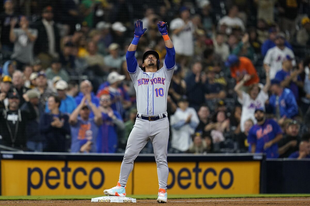 New York Mets' Eduardo Escobar reacts after hitting a two-RBI triple during the ninth inning of a baseball game against the San Diego Padres, Monday, June 6, 2022, in San Diego. (AP Photo/Gregory Bull)