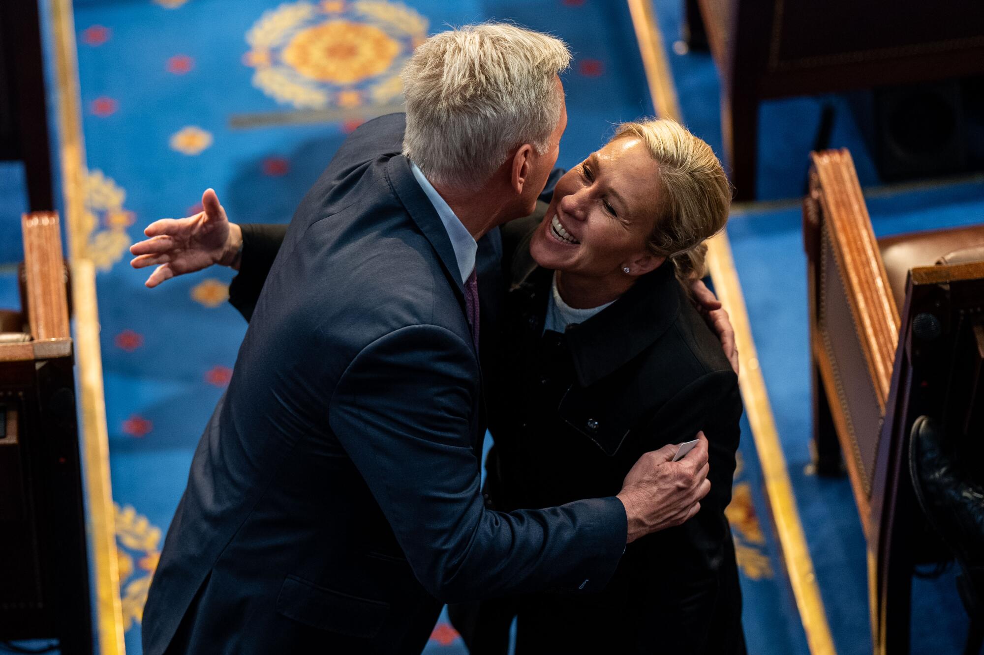  Kevin McCarthy hugs Rep. Marjorie Taylor Greene on the floor of the House