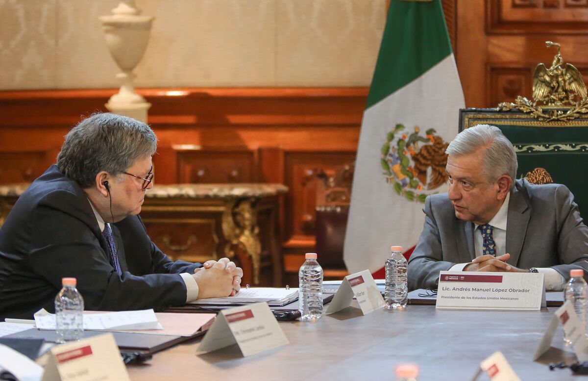Mexican President Andres Manuel Lopez Obrador meets with U.S. Atty. Gen. William Barr, left, in Mexico City on Dec. 5, 2019.