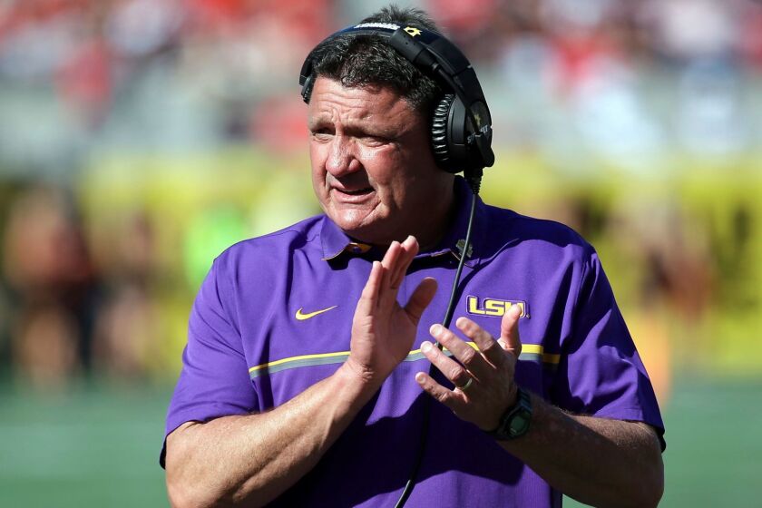 FILE - In this Dec. 31, 2016, file photo, LSU coach Ed Orgeron encourages players during the second half of the Citrus Bowl NCAA football game against Louisville in Orlando, Fla. Orgeron, a boisterous Cajun who is popular in his native Louisiana, is entering his first full season as LSUâs head coach after taking over four games into last season, when former coach Les Miles was fired. (AP Photo/John Raoux, File)
