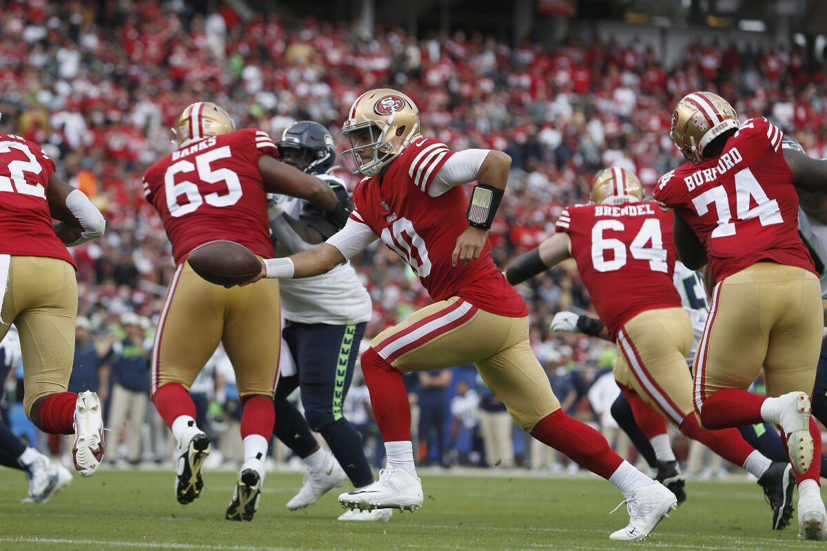 San Francisco 49ers quarterback Jimmy Garoppolo (10) looks to hand the ball off  against the Seattle Seahawks.