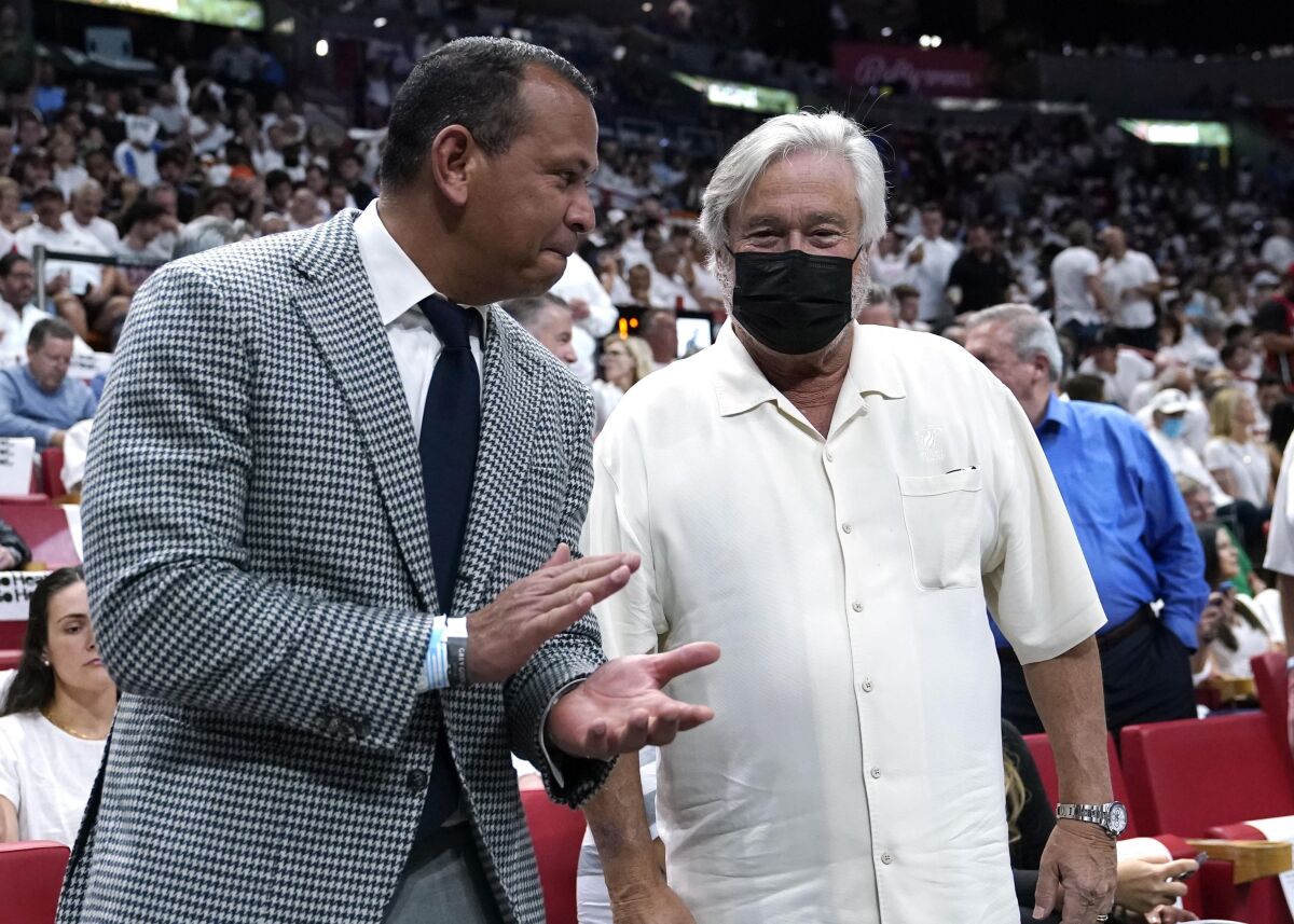 FILE - Former MLB player Alex Rodriguez applauds with Micky Arison, owner of the Miami Heat, before Game 1 of an NBA basketball Eastern Conference finals playoff series against the Boston Celtics, Tuesday, May 17, 2022, in Miami. Minnesota Timberwolves owner Alex Rodriguez said on Wednesday, July 13, 2022, the moves the team has made this summer left him even more bullish on the team's future.(AP Photo/Lynne Sladky, File)
