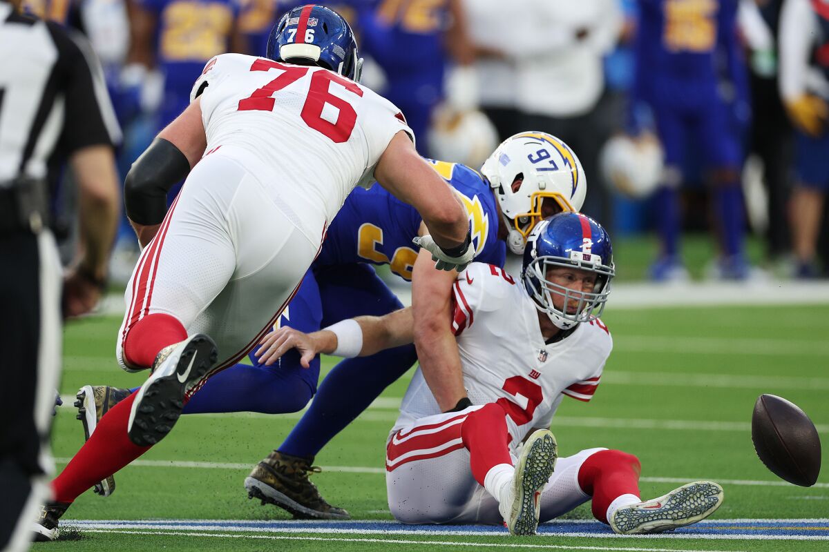 The Chargers' Joey Bosa (97) causes a fumble while sacking New York Giants quarterback Mike Glennon. 