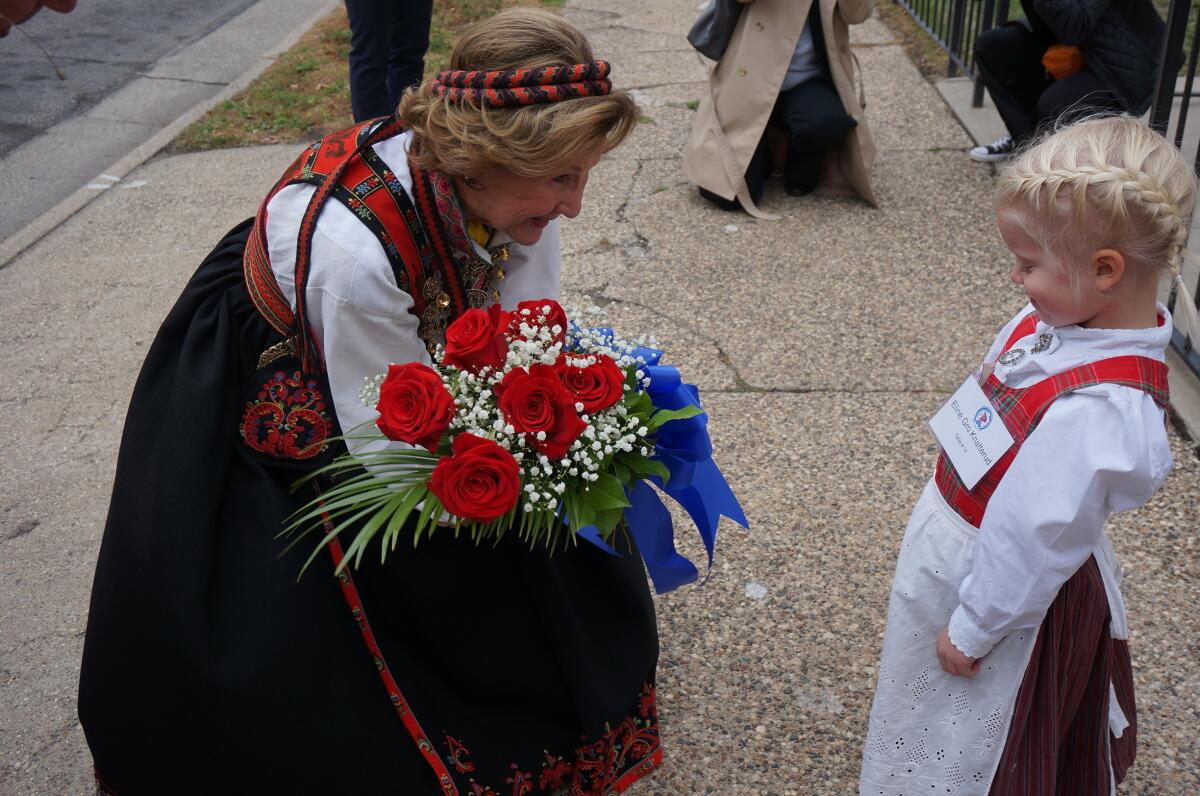 Eline Gro Knatterud, 4, greets Queen Sonja of Norway as she arrives to Den Norske Lutherske Mindekirke, the Norwegian Lutheran Memorial Church in Minneapolis, Sunday Oct. 16, 2022. (AP Photo/Giovanna Dell'Orto)