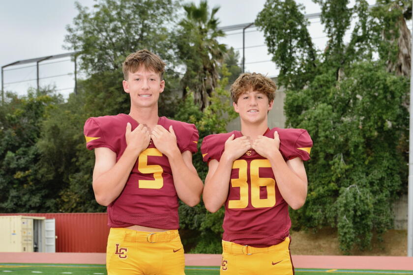 Quarterback Joe Bell (left) and his sophomore brother, Jake, a linebacker, are two of seven baseball players on La Canada.