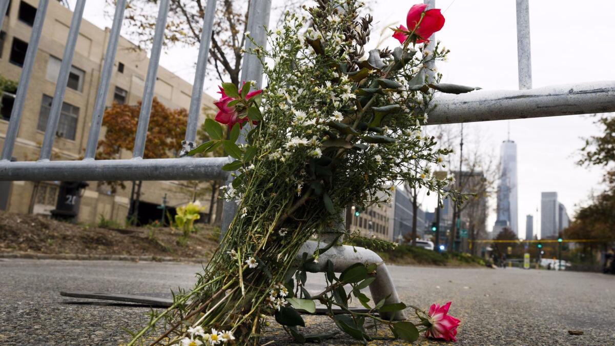 A bouquet of flowers leans against a police barricade in the bike path that was the scene of a terror attack in New York on Oct. 31.
