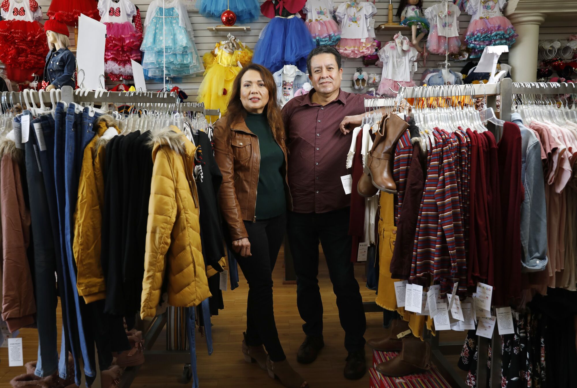 Gloria Verduzco and Carlos Salas at their retail clothing store 4Kids Clothes in Anaheim. 