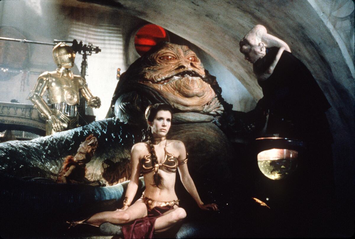 A woman in a space bikini sits in front of a blobby space villain. A droid is on the left and a sycophant is on the right