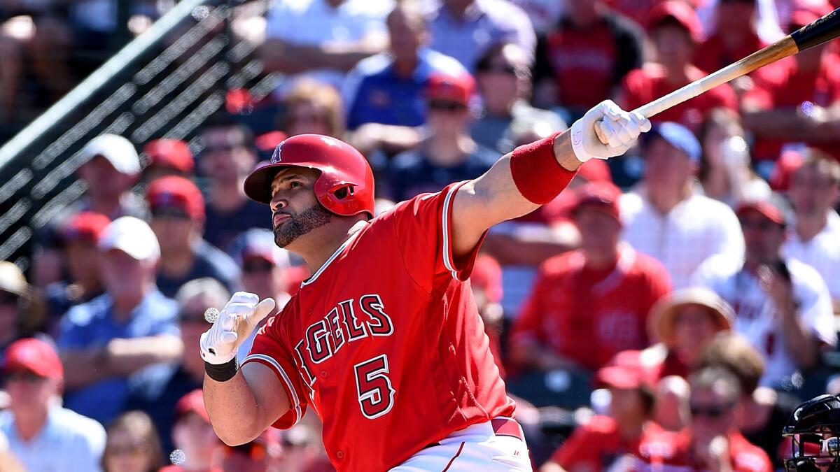 Angels first baseman Albert Pujols follows through on a two-run home run against the Giants during the first inning Saturday.