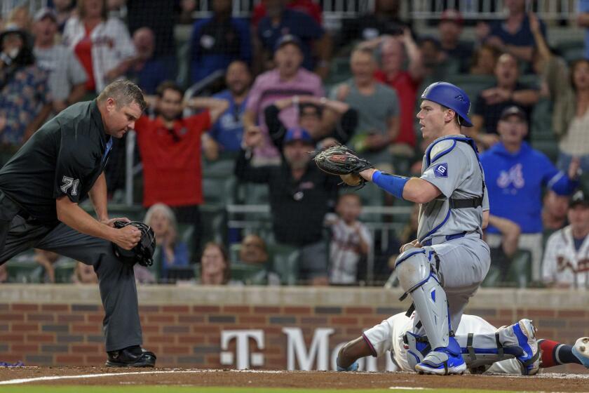 Los Angeles Dodgers catcher Will Smith tags Atlanta Braves' Michael Harris II, right, at home plate in the third inning of a baseball game, Monday, Sept. 16, 2024, in Atlanta. (AP Photo/Jason Allen)