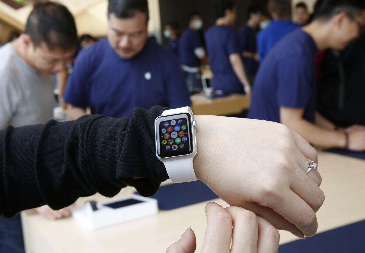 A customer tries on an Apple Watch at an Apple store in Hong Kong on Friday.