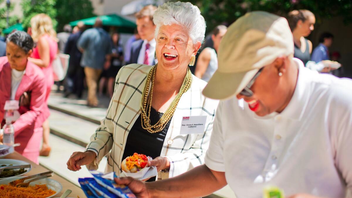 Rep. Grace Napolitano, D-Norwalk, prepares a hot dog during the American Meat Institute's annual Hot Dog Lunch.