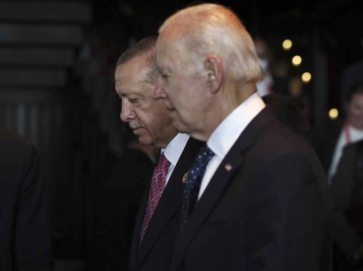 FILE - Turkish President Recep Tayyip Erdogan, left, walks with U.S. President Joe Biden during the G20 leaders' summit in Nusa Dua, Bali, Indonesia, Nov. 15, 2022. Biden administration officials are toughening their language toward NATO ally Turkey as they try to talk Turkish President Recep Erdogan out of launching a bloody and destabilizing ground offensive against American-allied Kurdish forces in neighboring Syria. (Made Nagi/Pool Photo via AP)