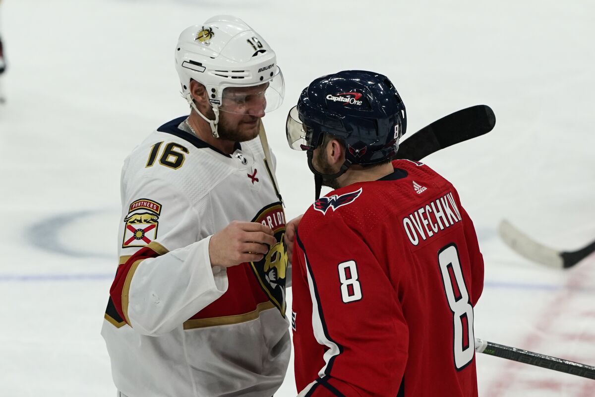 Florida Panthers center Aleksander Barkov (16) and Washington Capitals left wing Alex Ovechkin (8) react after Game 6 in the first round of the NHL Stanley Cup hockey playoffs, Friday, May 13, 2022, in Washington. (AP Photo/Alex Brandon)