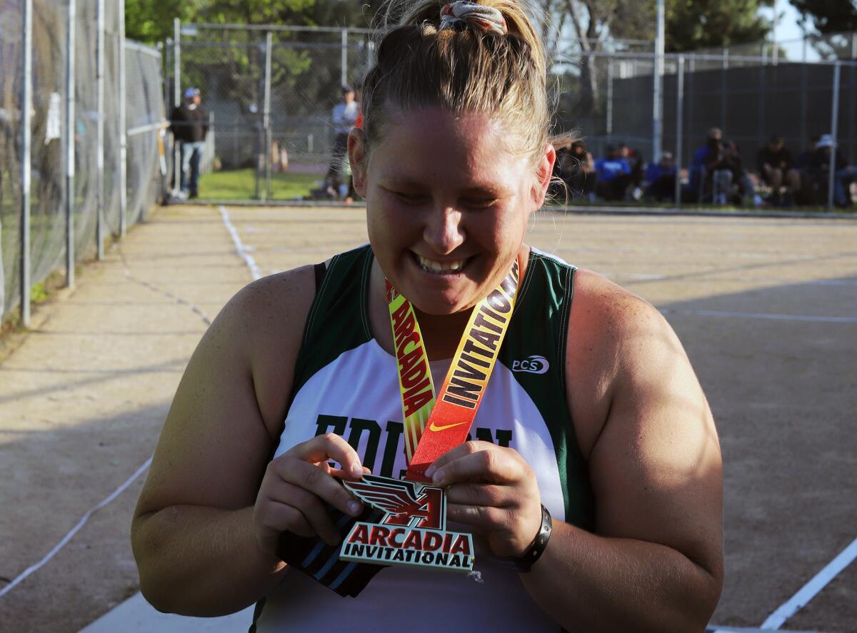 Edison's Alexa Sheldon is all smiles holding her medal after winning the girls' shot put in the Arcadia Invitational.