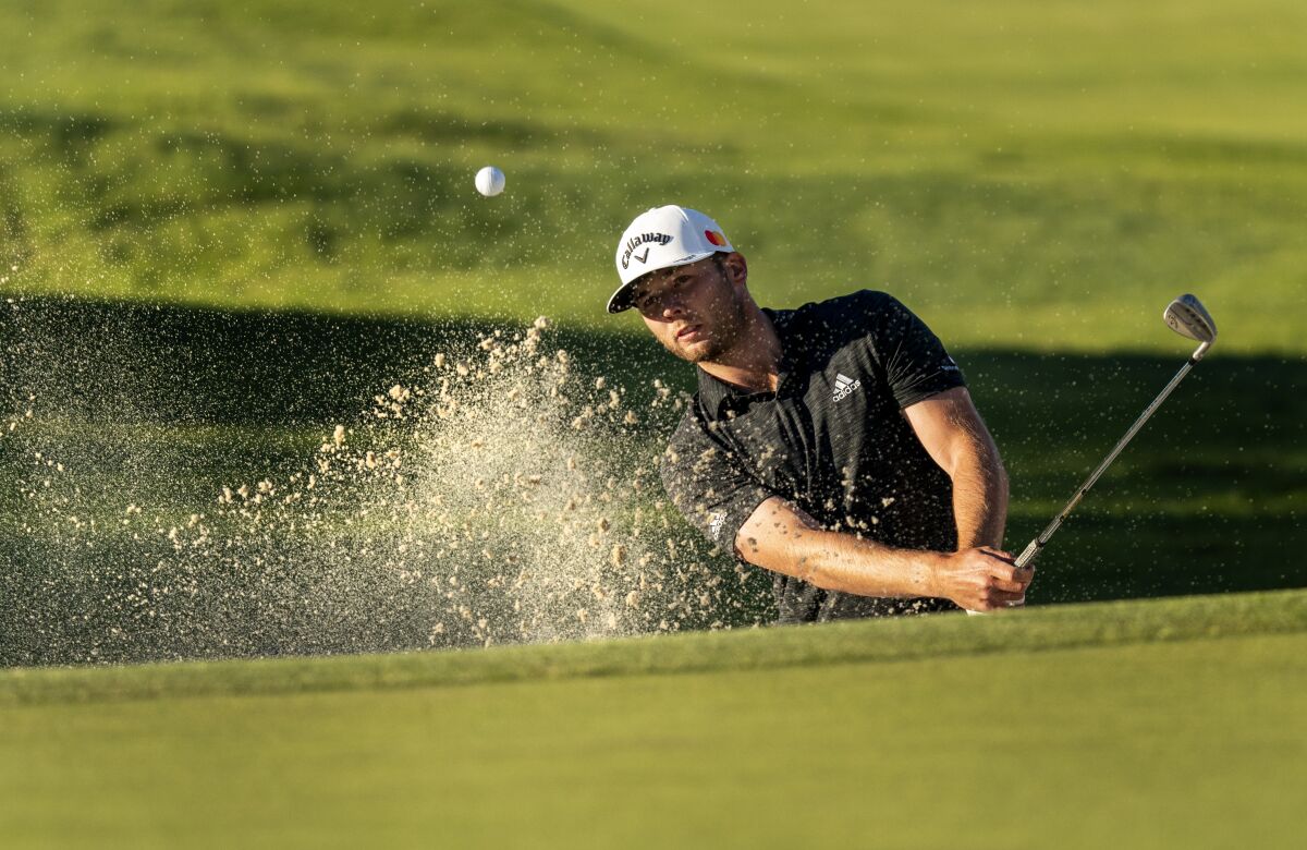 Leader Sam Burns hits out of a greenside bunker to set up a birdie putt on No. 10 on Feb. 20, 2021 in Pacific Palisades.