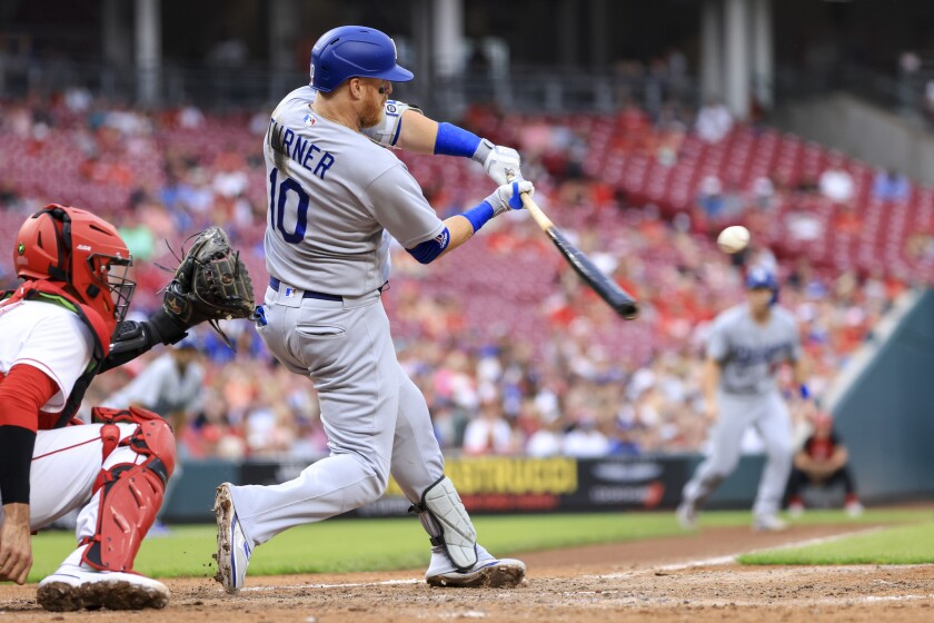 The Dodgers' Justin Turner hit a sacrificial fly ball against the Reds on Wednesday.