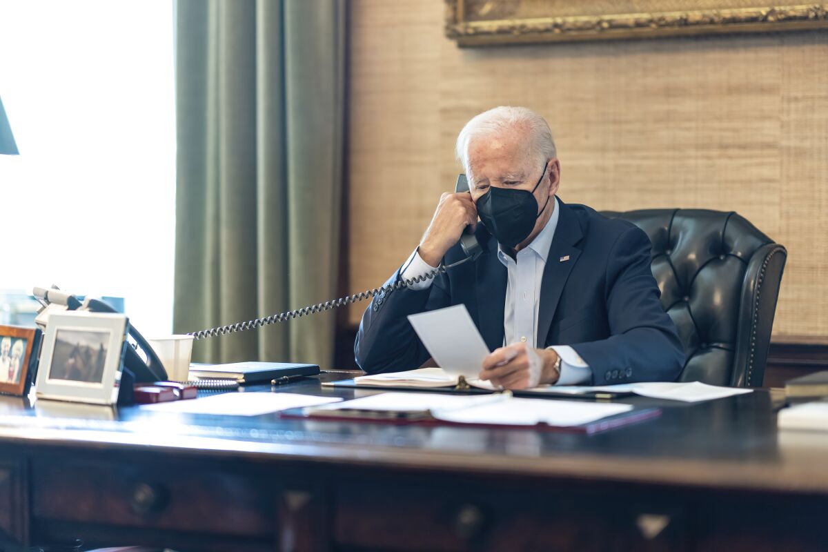 In this photo provided by The White House, President Joe Biden talks on the phone with his national security team.