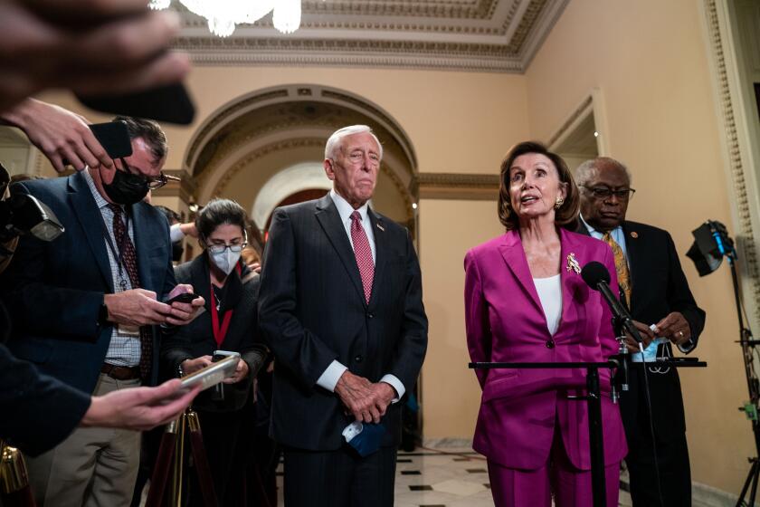 WASHINGTON, DC - NOVEMBER 05: House Majority Leader Steny Hoyer (D-MD), Speaker of the House Nancy Pelosi (D-CA), and House Majority Whip Jim Clyburn (D-SC) at a news conference on the House side of the U.S. Capitol Building on Friday, Nov. 5, 2021 in Washington, DC. After months of negotiations between progressives and moderates, House Democrats hope to hold votes on the bipartisan infrastructure bill and social spending bill on Friday. (Kent Nishimura / Los Angeles Times)